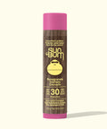 Sun Bum lip balm stick with pink cap and brown body on a white background