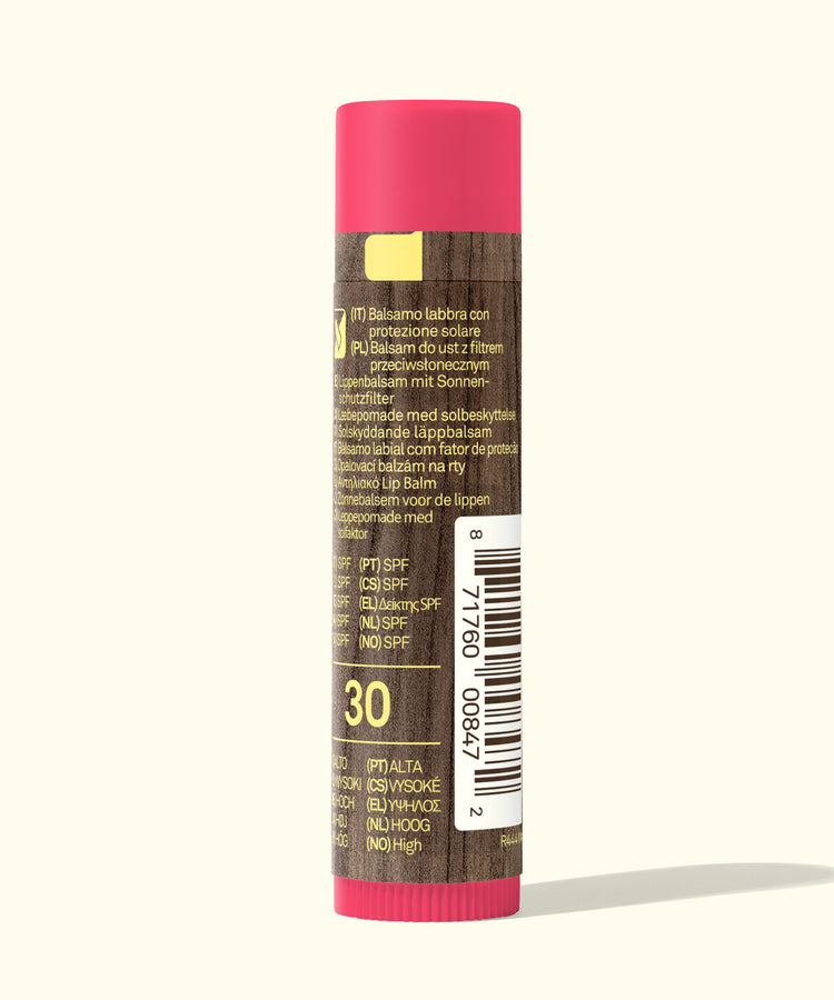 Lip balm with pink cap and brown body on a white background