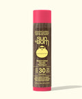 Sun Bum lip balm tube with pink cap and brown body on a white background