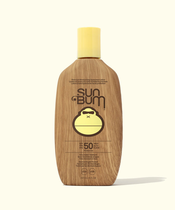 Sun Bum sunscreen bottle with wooden texture on a white background
