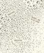 Pattern of water droplets on a textured surface with text overlay.