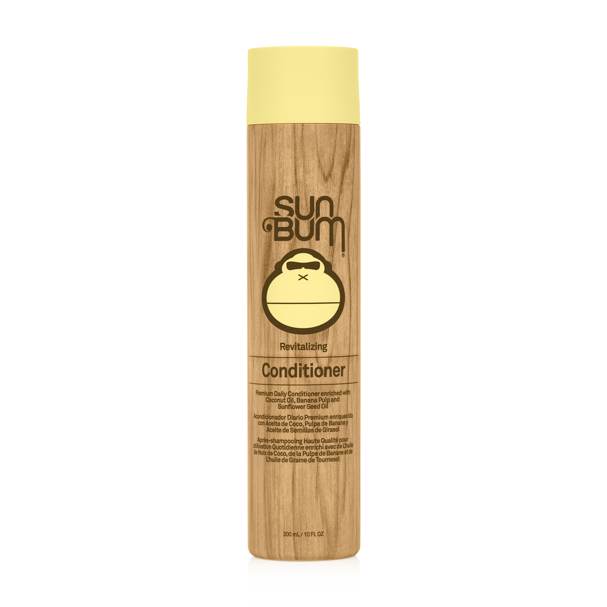 A bottle of Sun Bum Revitalizing Conditioner with a beige label featuring the brand's logo and the text 'NEW DELICAMUM'. The bottle is tall and slender with a wooden appearance.